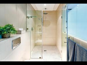 a bathroom with a shower with a glass door at The Crystal 203 Camps bay - back-up power in Cape Town