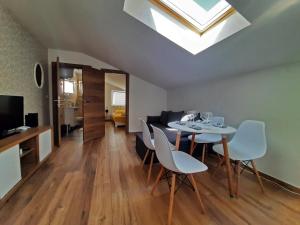 a living room with a table and chairs and a skylight at Apartments Center Opatija Ziric in Opatija