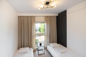 Кровать или кровати в номере Harmonia Apartament with Parking