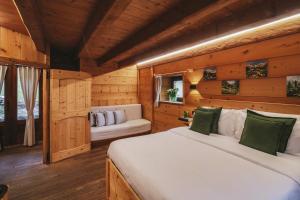 a bedroom with two beds in a wooden cabin at Agriturismo Ferdy in Lenna