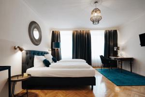 ein Hotelzimmer mit 2 Betten und einem Schreibtisch in der Unterkunft Hotel Fletzinger in Wasserburg am Inn