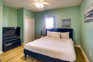 a bedroom with a bed and a flat screen tv at Barefoot Resort Condo with Pools and Balcony! in Myrtle Beach +31 photos