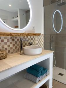 a bathroom with a sink and a mirror at Casa Avellana 37 in Denia