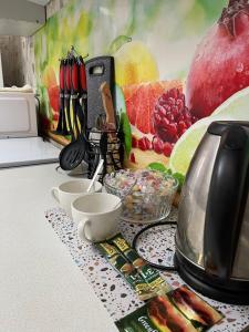 un bancone cucina con tavolo, utensili e cibo di 1-комнатная квартира в центре a Kökşetaw