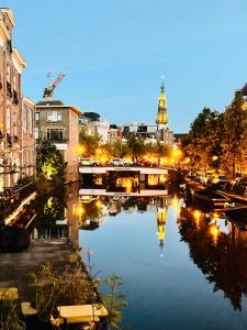 a bridge over a river in a city at night at Leiden City Centre Canal View or Terrace View Apartments in Leiden