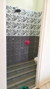 a bathroom with a shower with a black and white wallpaper at Homestay Dena Moon Inn in Tumpat