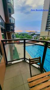 a balcony with a view of a swimming pool at Bliss by Zen Residences at The Radiance Manila Bay in Manila