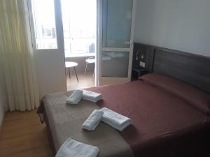 Ein Bett oder Betten in einem Zimmer der Unterkunft Pensión KM66 Palas de Rei