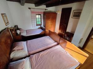 a bedroom with two beds and a window at Őrségi Porta in Magyarszombatfa