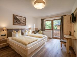 a bedroom with a large wooden bed in a room at Landhaus Christina in Brandberg