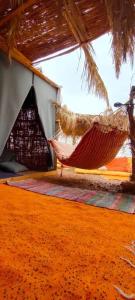 a room with a hammock and a tent at Fully equipped Remote off-grid Solar Wooden Home in Dahab