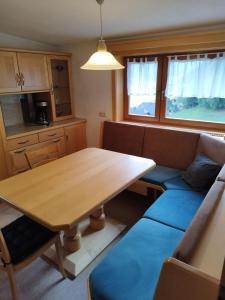 a living room with a wooden table and a couch at Haus Maria in Patergassen