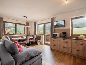 a kitchen and living room with a couch and a table at Landhaus Christina in Brandberg