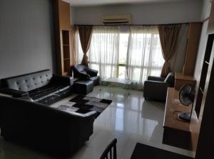 a living room with black furniture and a large window at Dream East Lake in Seri Kembangan