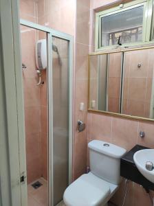 a bathroom with a toilet and a sink and a mirror at Dream East Lake in Seri Kembangan