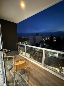 a balcony with a table and chairs on top of a building at Monoambiente 50 y 28 in La Plata