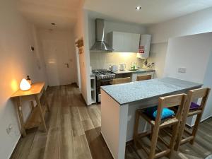 a kitchen with a table and a counter top at Monoambiente 50 y 28 in La Plata +4 photos