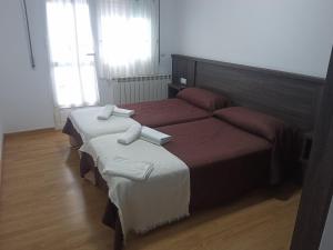 Ein Bett oder Betten in einem Zimmer der Unterkunft Pensión KM66 Palas de Rei