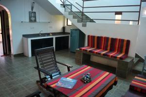 a living room with a couch and a table and stairs at Sri Beach Bungalows And Villa in Marawila