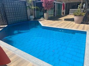 a swimming pool with blue tiles in a house at Hotel Pousada Irmaos Freyhardt in Rio de Janeiro