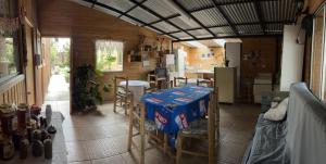 a kitchen with a table and chairs in a room at Hostel San Felipe in San Felipe