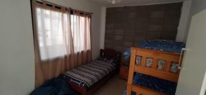 a bedroom with a bed and a dresser and a window at HERMOSA CASA 2 DORMITORIOS EN POTRERO DE GARAY in Potrero de Garay