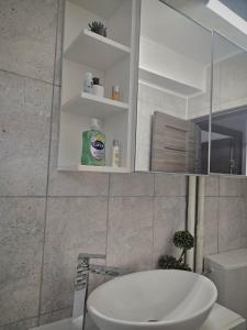 a bathroom with a sink and a toilet and a mirror at Cazare Ploiesti in Ploieşti