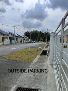 a outside parking sign on the side of a street at Homestay KLIA Sweet Sky in Sepang