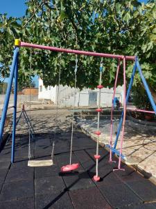 an empty playground with swings in a park at Quinta D'Avó in Setúbal