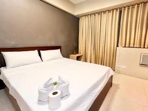una camera da letto con un letto e un rotolo di carta igienica di Elegant Condo Hotel across NAIA Airport Terminal 3 Newport City a Manila
