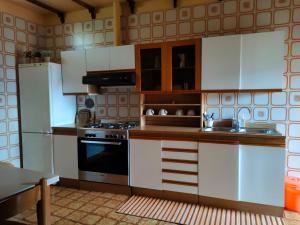 a kitchen with white cabinets and a stove top oven at Antica Terrazza in Terni