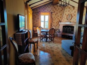 a living room with a table and chairs and a fireplace at Antica Terrazza in Terni