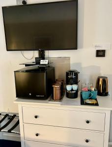 a tv sitting on top of a dresser at Lochindaal Hotel in Port Charlotte