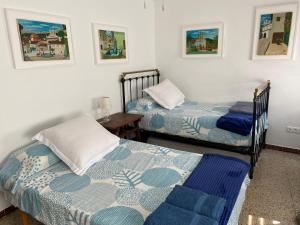 Habitación con 2 camas individuales y mesa. en Arenalita en El Arenal