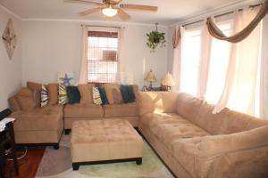 a living room with two couches and a ceiling fan at Decatur Dream in Decatur