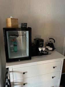 a white dresser with a tv on top of it at Lochindaal Hotel in Port Charlotte