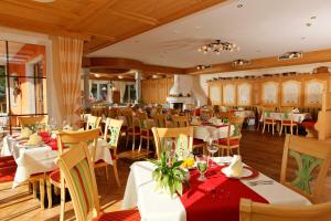 a dining room with white tables and chairs at Der Grubacher in Gerlos