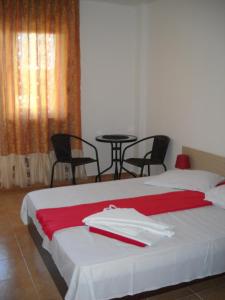a bedroom with a bed with a red towel on it at Vila Bucura 19 in Venus +21 photos