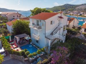 an aerial view of a house with a swimming pool at Villa Danijela with heated pool,jacuzzi and sauna in Seget Vranjica