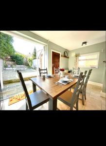 a dining room with a wooden table and chairs at Vista homes in Roundhay