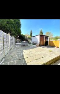 une terrasse avec une table de pique-nique et une clôture dans l'établissement Vista homes, à Roundhay