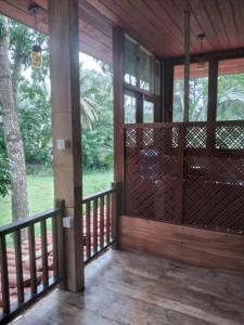 eine abgeschirmte Veranda mit Blick auf einen Baum in der Unterkunft Green Herbal Ayurvedic Eco-Lodge in Galle