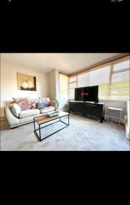 a living room with a couch and a table at Vista homes in Roundhay