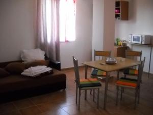 a living room with a table and a couch at Vila Bucura 19 in Venus