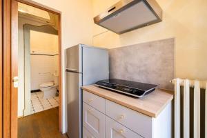 a kitchen with a refrigerator and a sink at Appartamento elegante e centrale La Foglia D'Oro in Bologna +12 photos