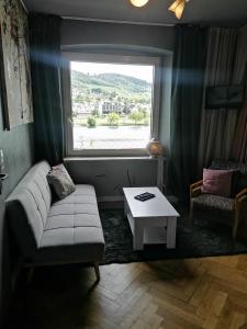 a living room with a couch and a window at Klein aber fein in Alf