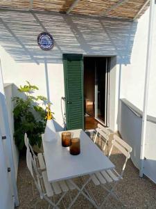 a white table and chairs on a patio at Olivietta Suite in Cervia