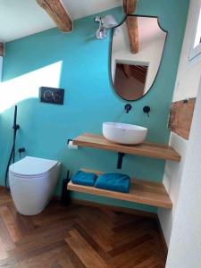 a bathroom with a sink and a toilet and a mirror at Olivietta Suite in Cervia +13 photos