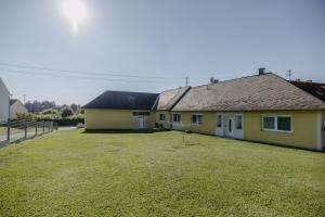 a house with a large yard in front of it at Landhaus ANDREA in Litzelsdorf