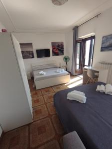 a bedroom with two beds and a living room at B&B Sentiero Italia in Latronico